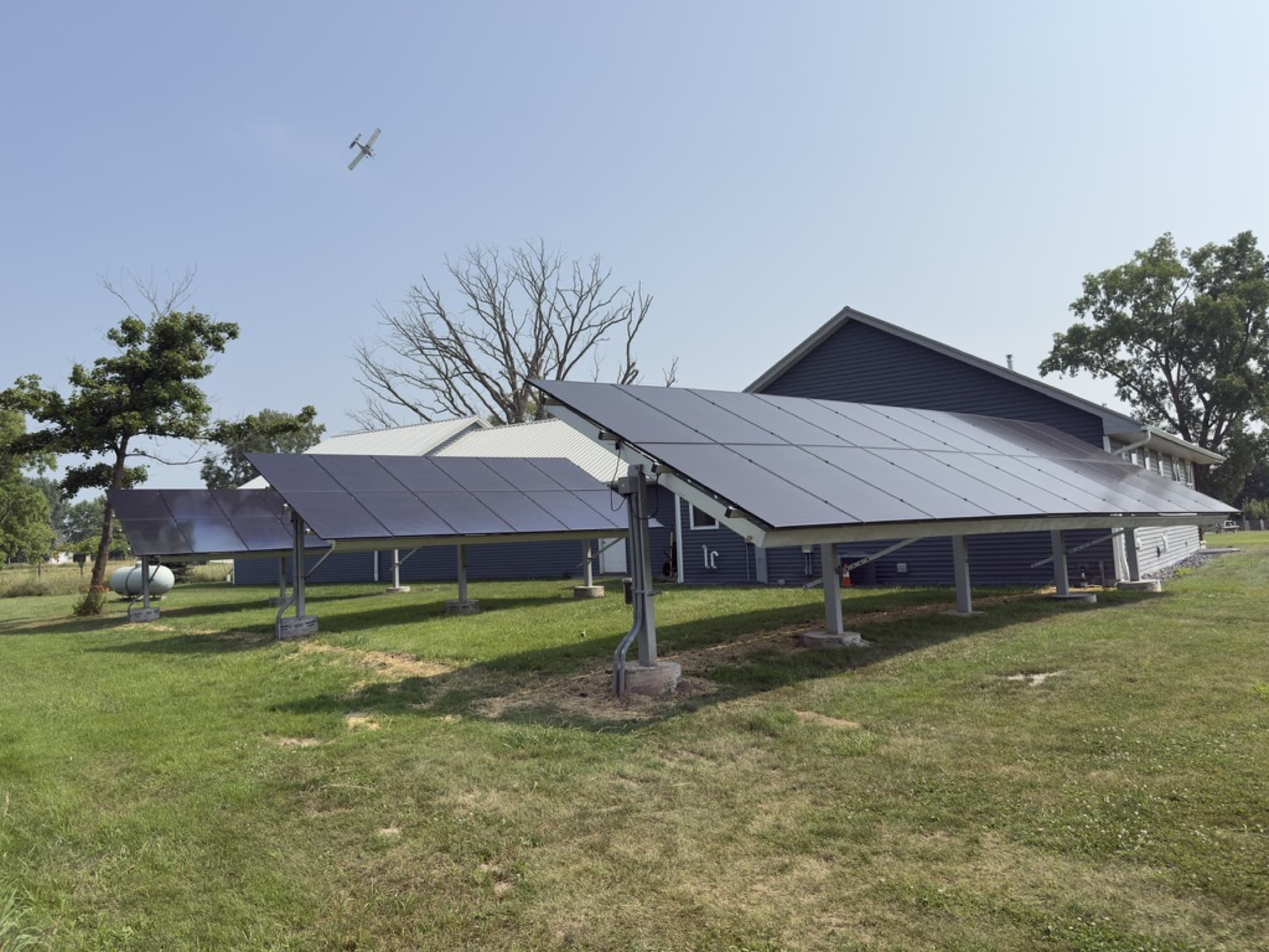 Two ground-mounted solar arrays beside a home in Brillion, Wisconsin
