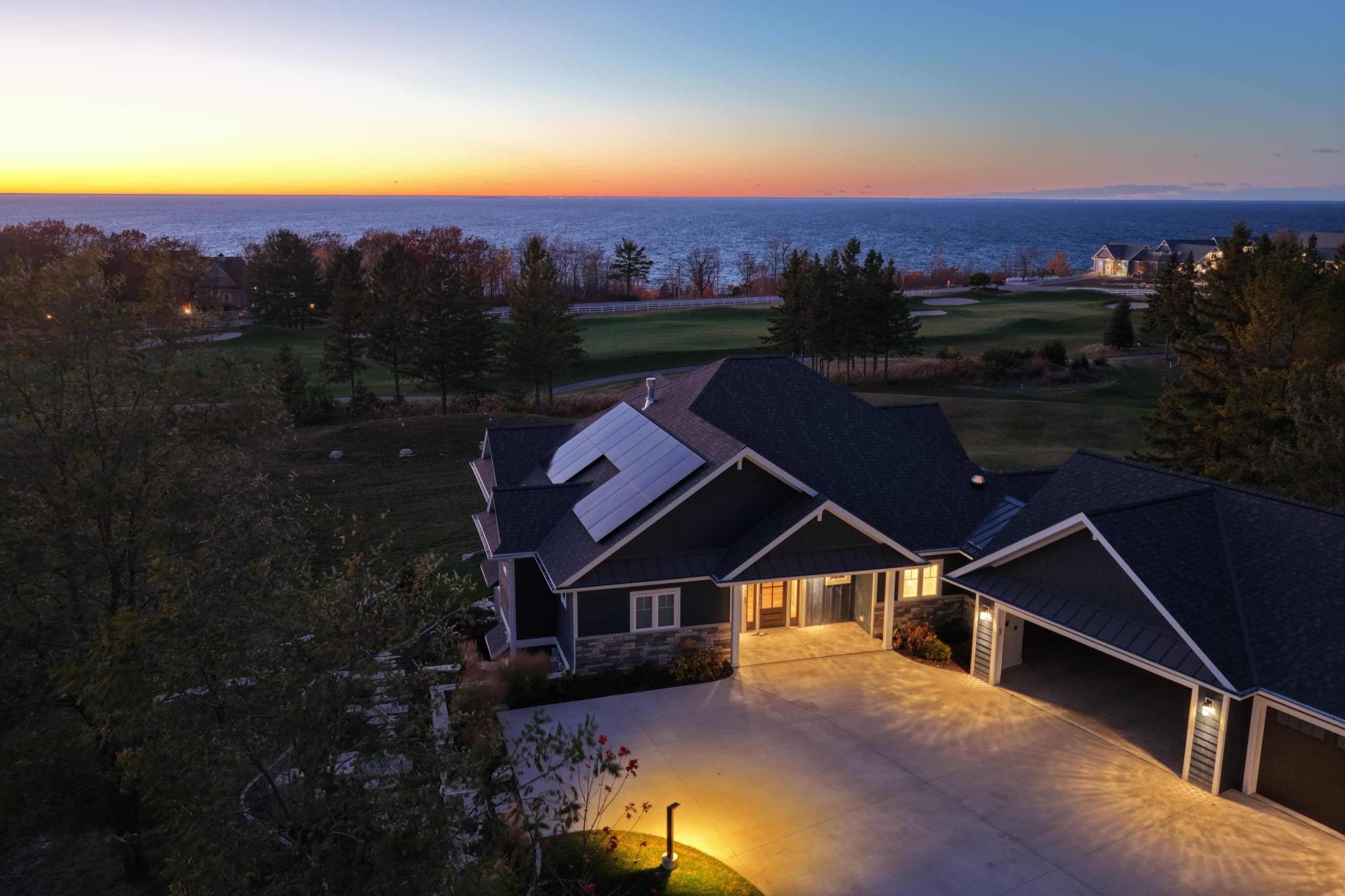 Door County home with rooftop solar at dusk overlooking the bay, Egg Harbor Wisconsin