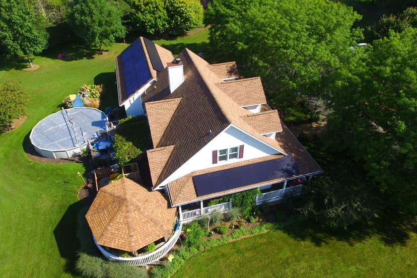 Aerial view of an all-black rooftop solar array on a Manitowoc, Wisconsin home