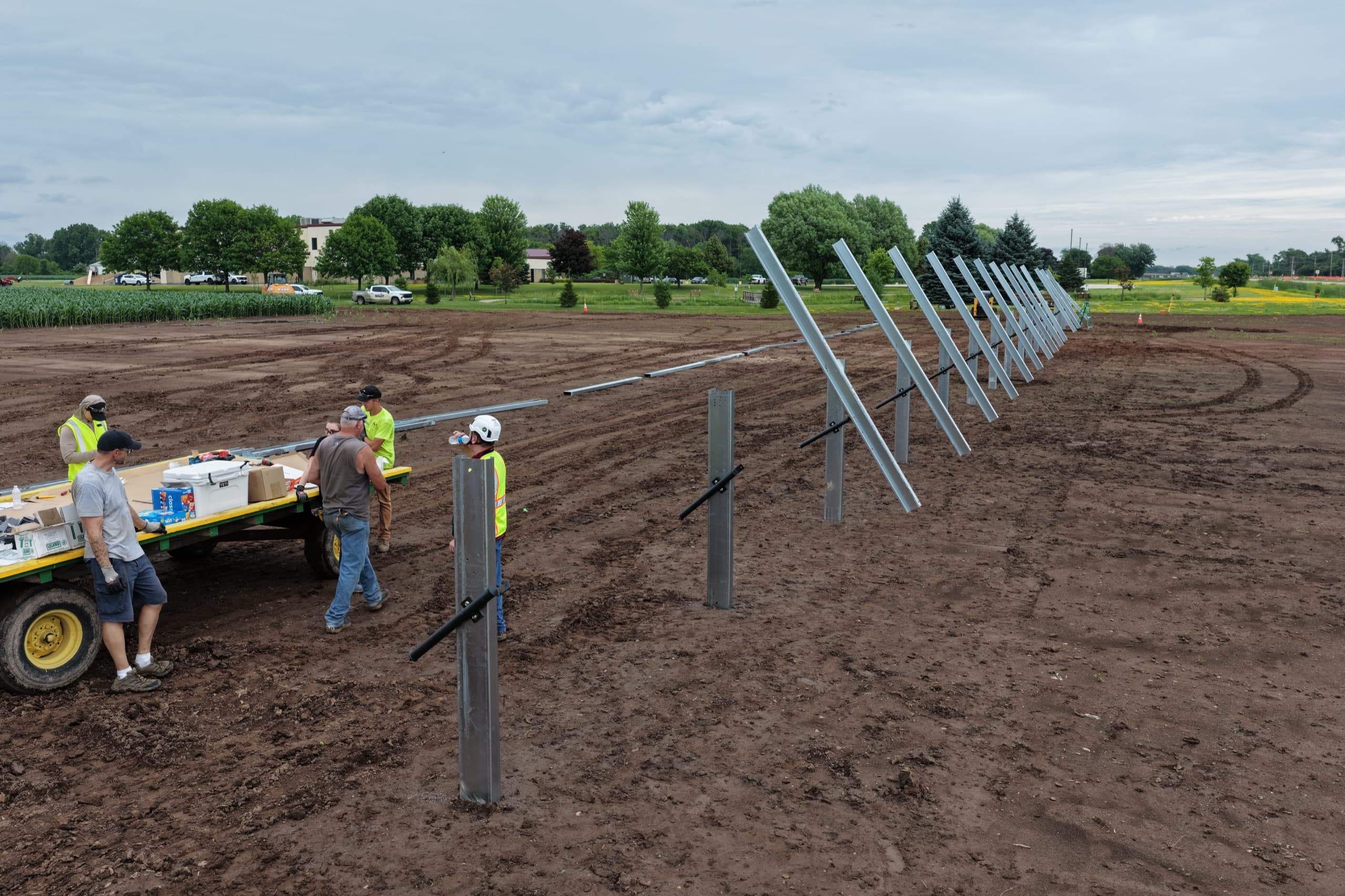 Sevens Solar crew installing ground-mount racking at Christ the Rock in Menasha, Wisconsin