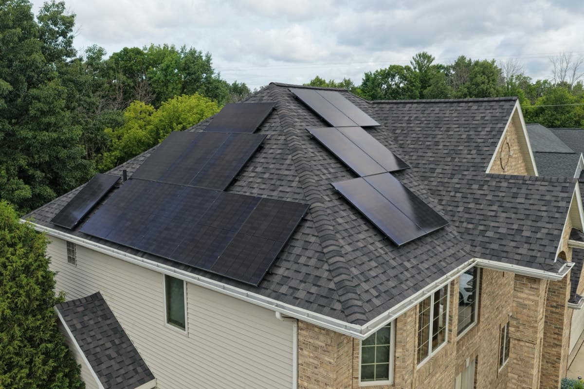 All-black solar array sitting flush across two roof planes on a Green Bay, Wisconsin home, nearly indistinguishable from the shingles