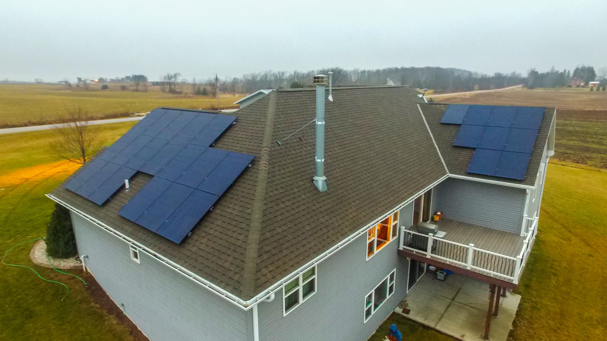 Drone view of the finished solar array across two roof faces of the same Wisconsin home shown in the sample proposal